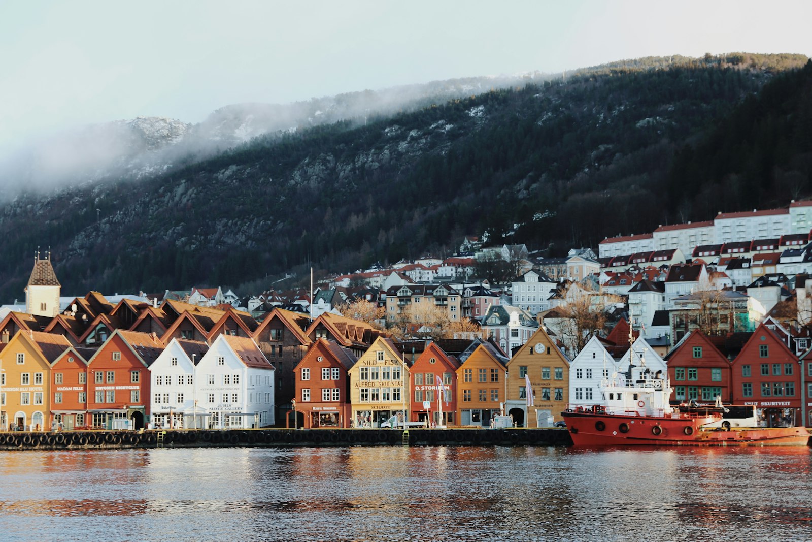 The colourful wooden Hanseatic houses of Bergen's Bryggen wharf reflected in the harbour