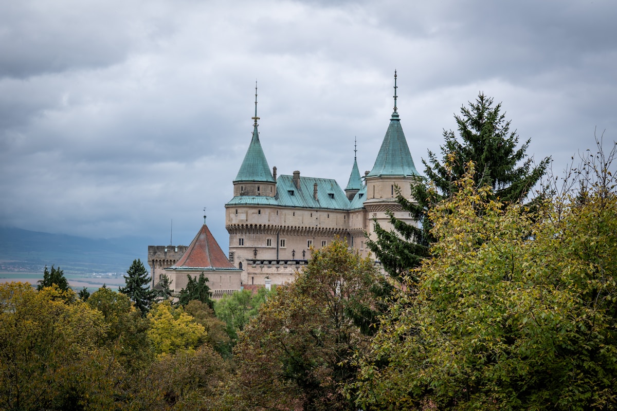 Bojnice Castle with its green spires rising above the trees