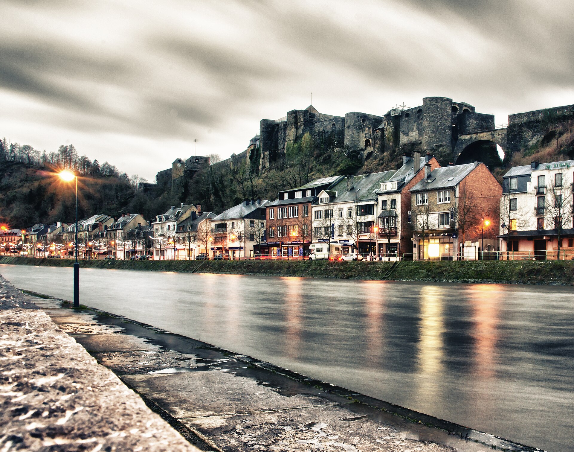 The medieval fortress of Bouillon stretched along its rocky ridge above the Semois river at dawn
