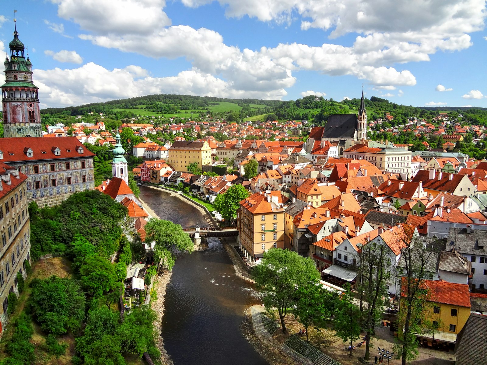 Český Krumlov's red rooftops wrapped in a bend of the Vltava river beneath its castle