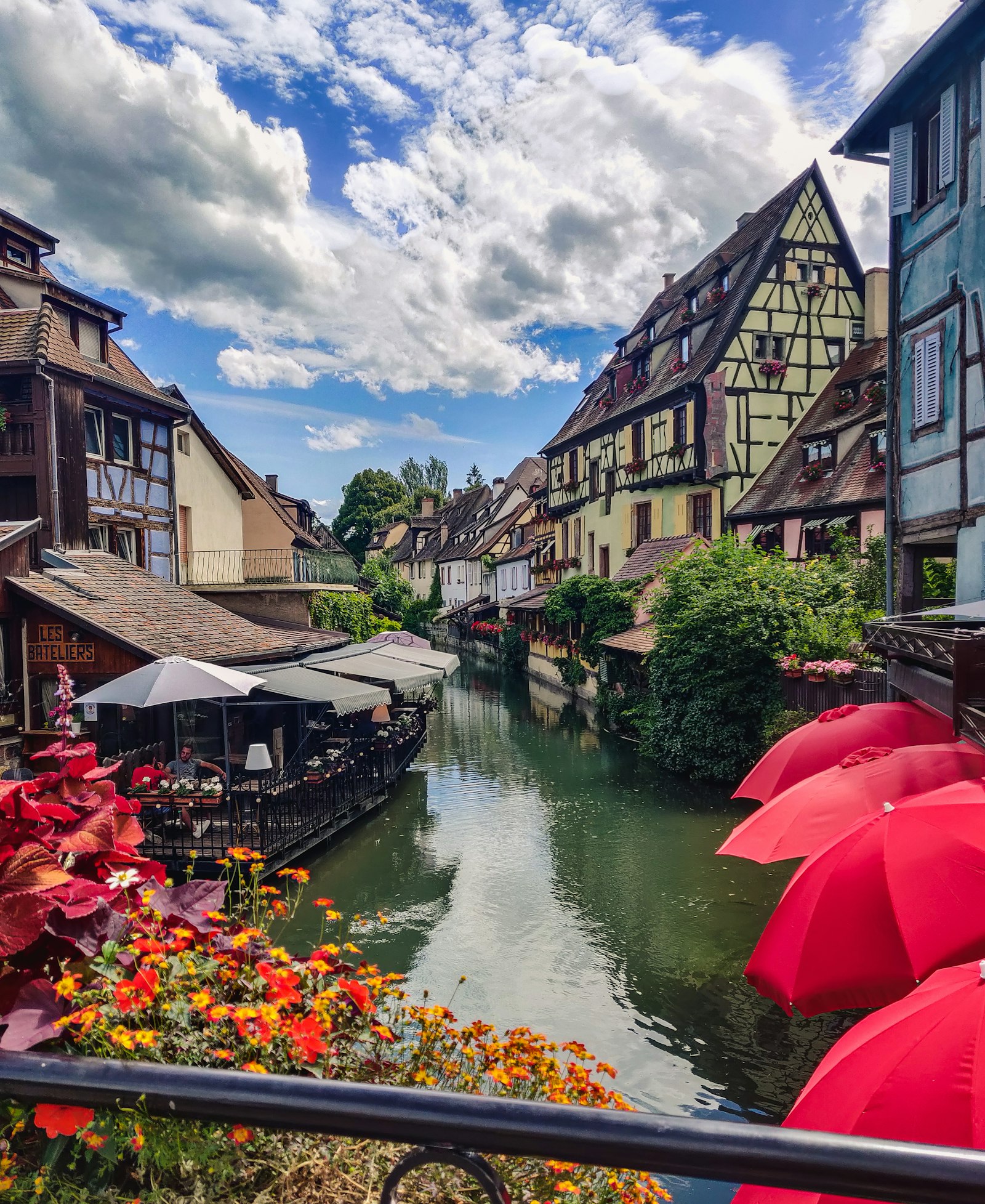 Half-timbered houses reflected in the canals of Colmar's Little Venice