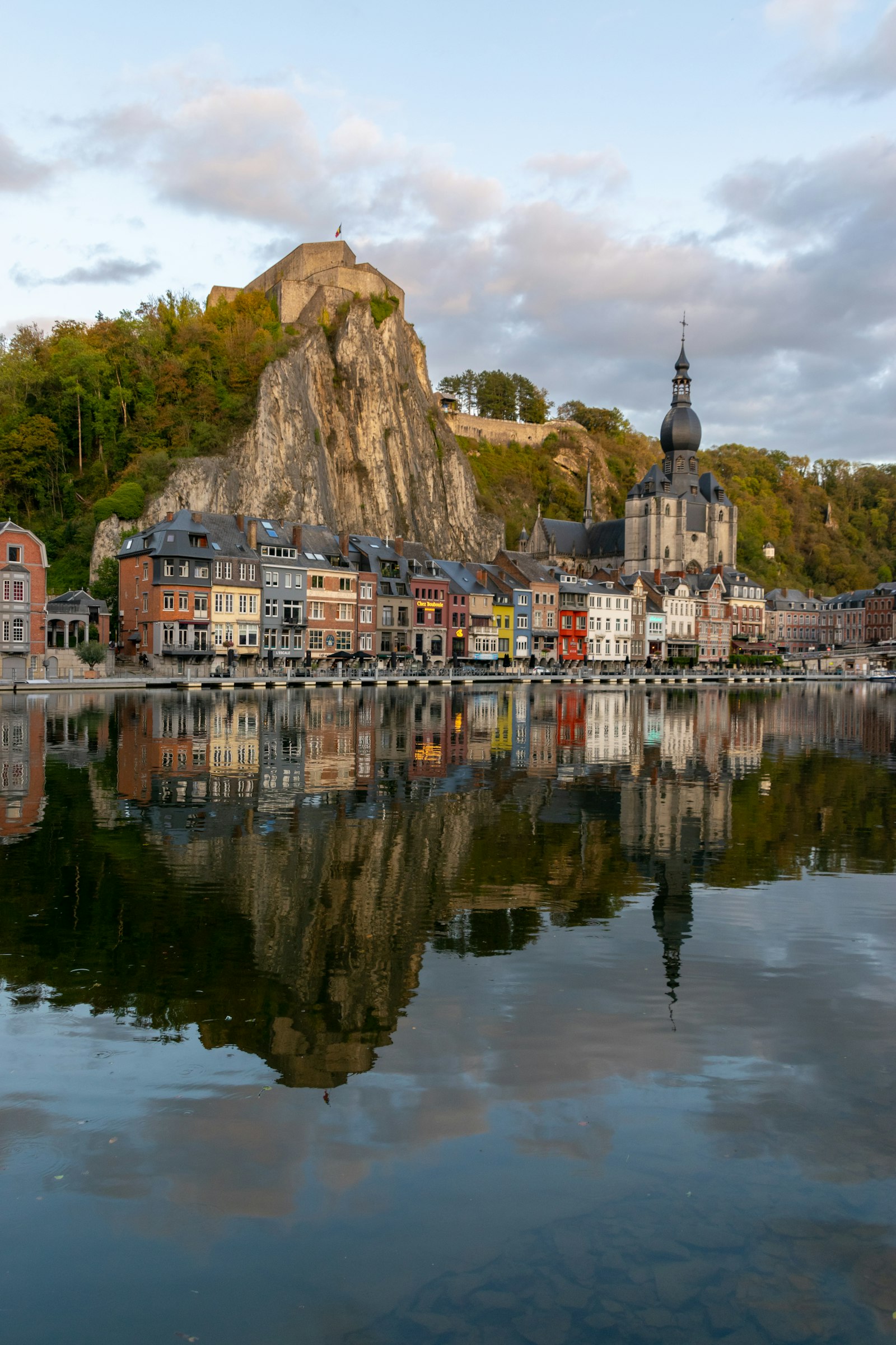 The houses of Dinant squeezed between the Meuse river and a cliff beneath its citadel and bulbous church
