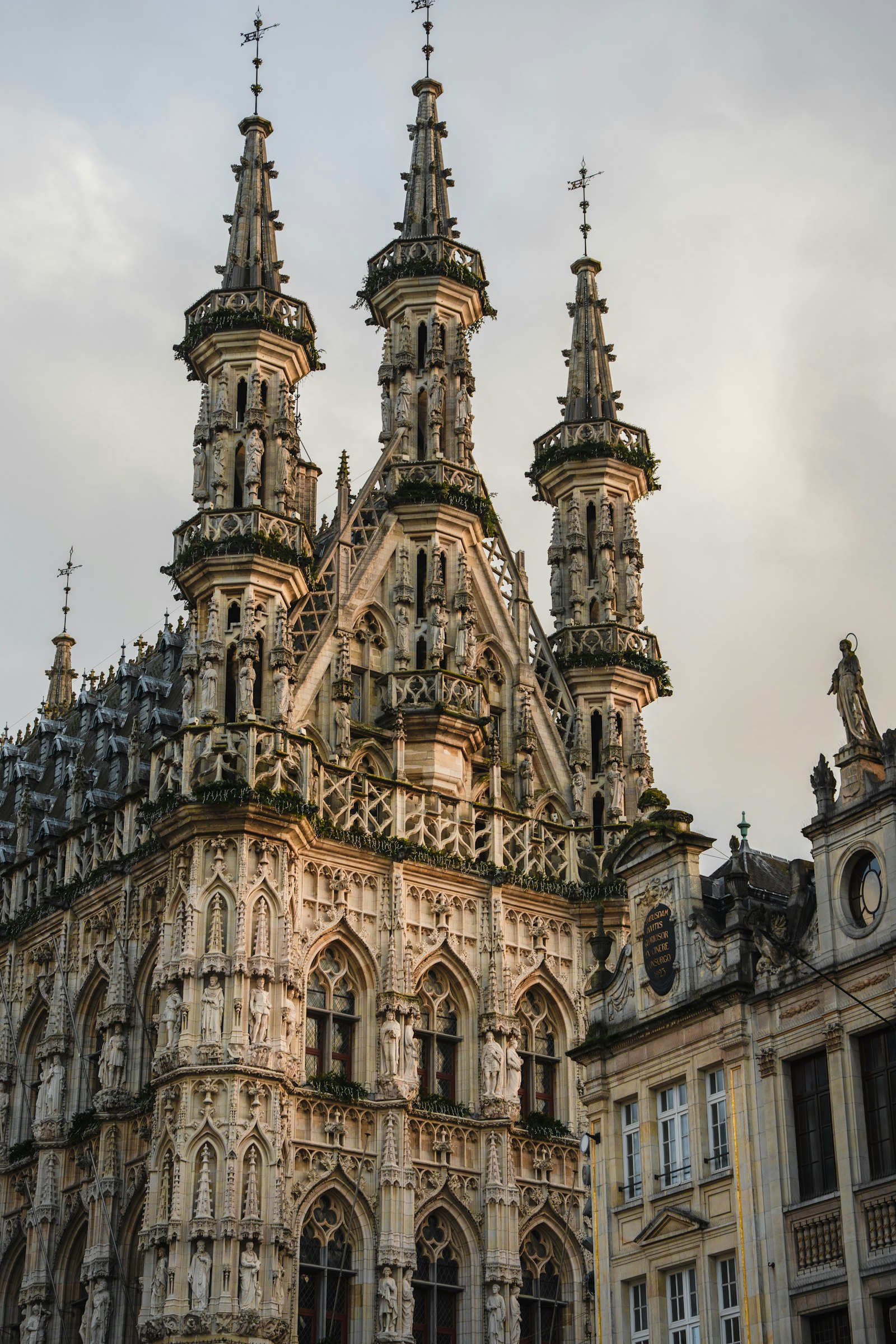 The intricately carved Gothic town hall of Leuven covered in statues