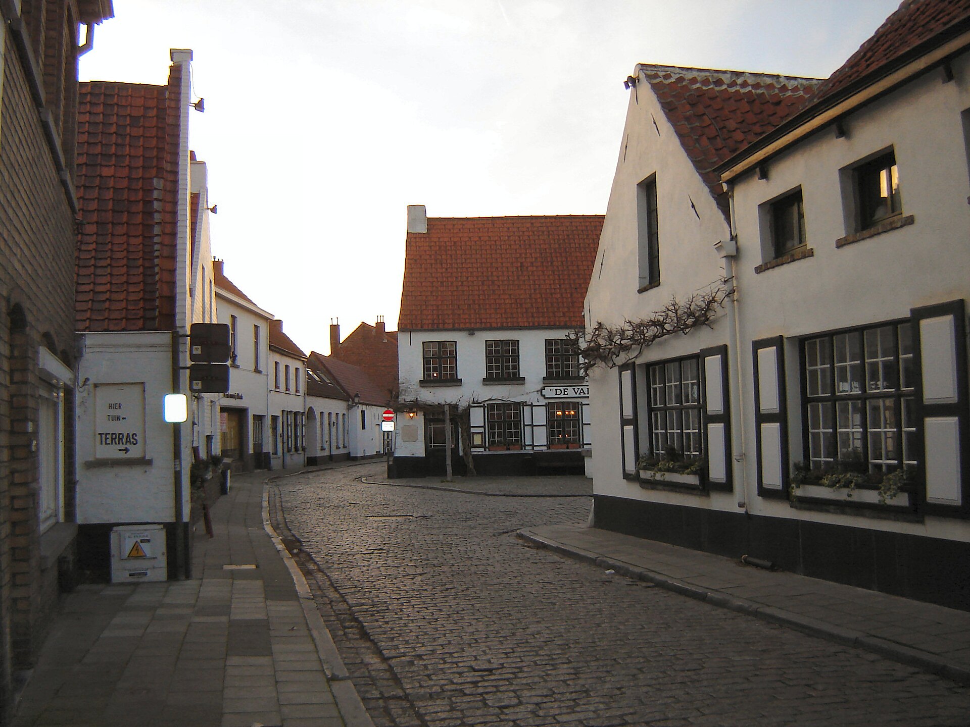 A quiet street of whitewashed cottages in Lissewege, the white village near Bruges