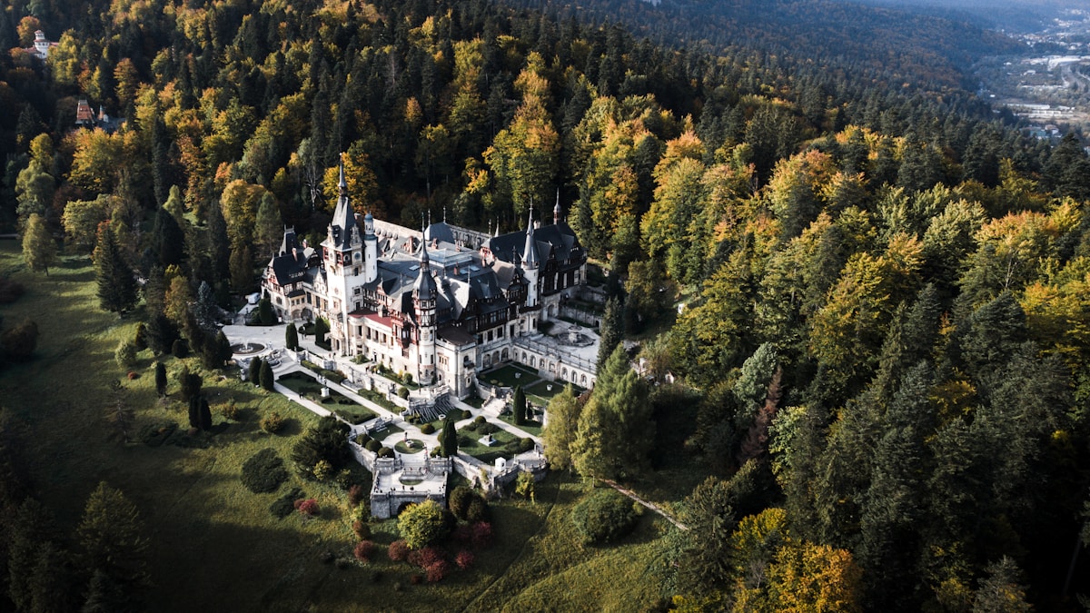 Peleș Castle set among the wooded Carpathian mountains