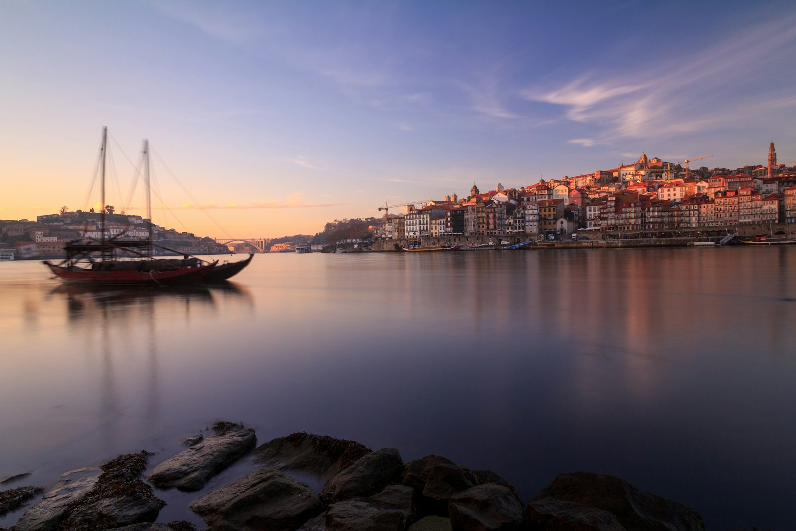 Porto's pastel houses stacked up the hillside above the Douro river and its iron bridge
