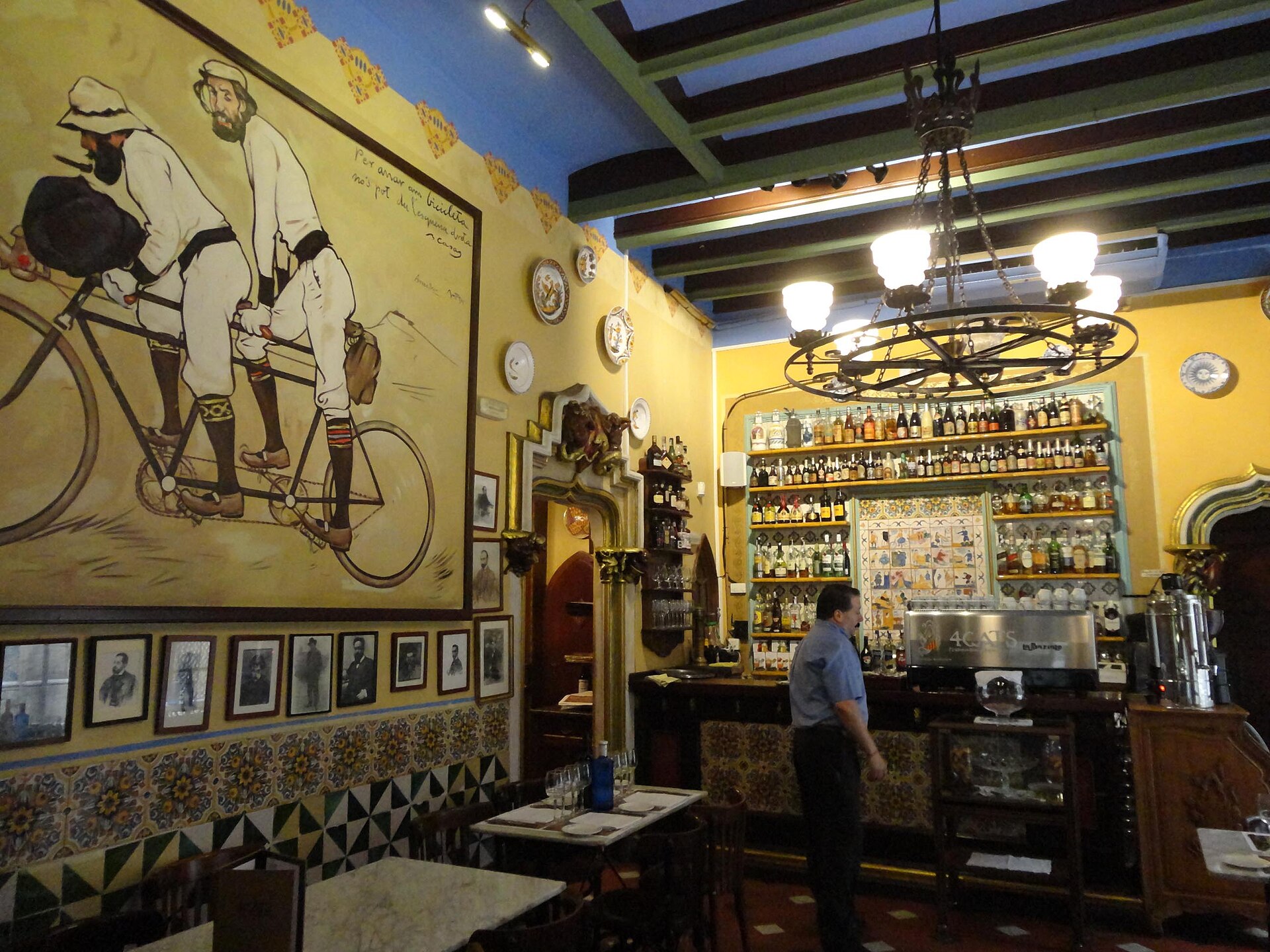 The Modernista interior of Els Quatre Gats in Barcelona, with its arches, ironwork and old paintings