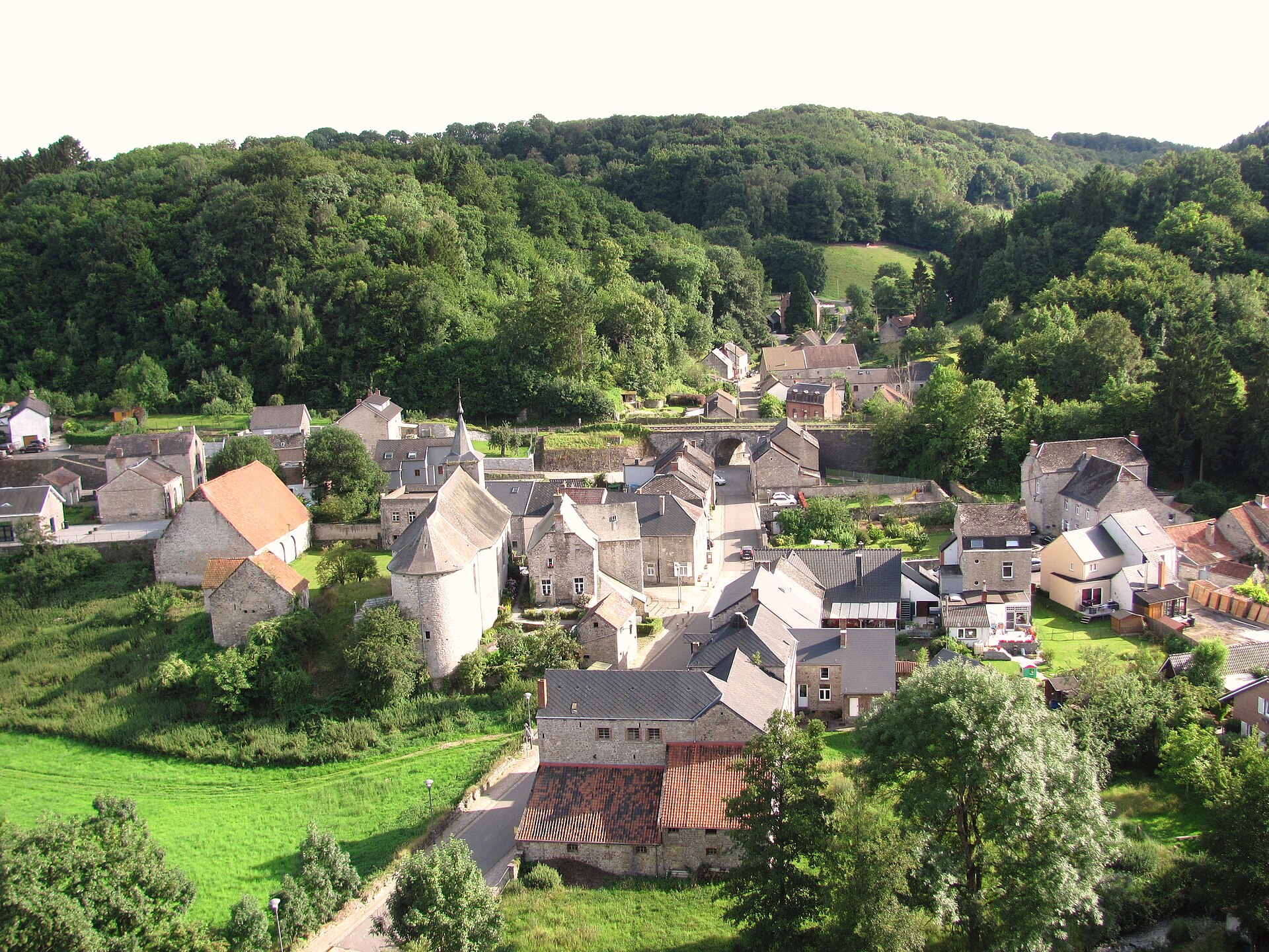 The grey limestone houses of Sosoye in the green Molignée valley