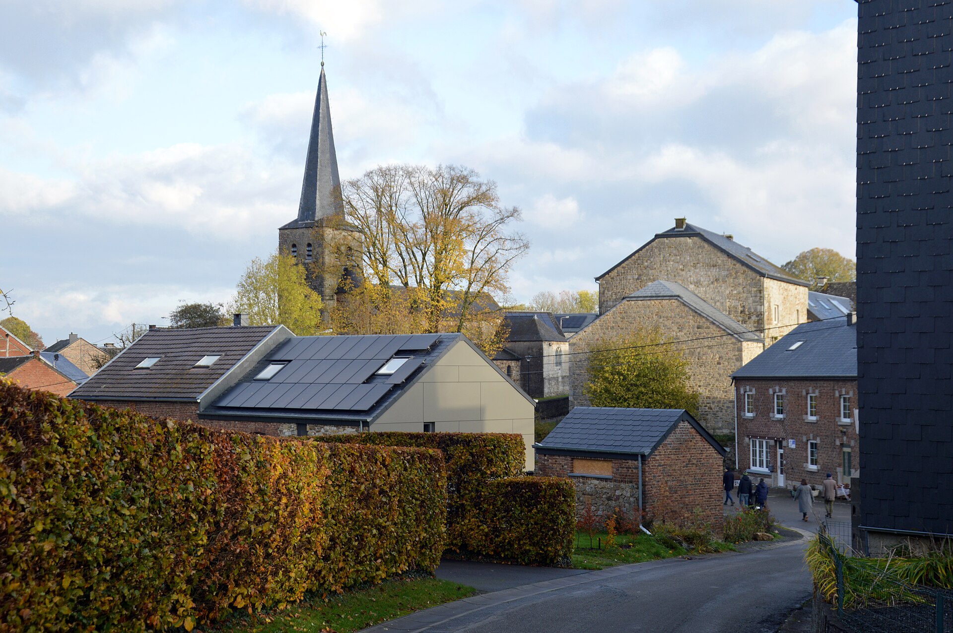 A street view down Rue des Dolmens between the stone houses of Wéris in the Ardennes